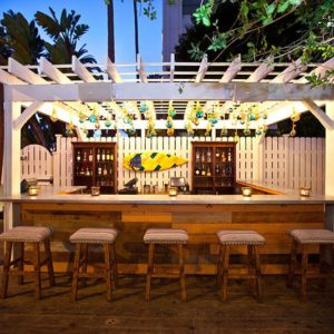 Outside Deck Image with bar stools and wide variety of liquor displayed