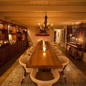 State Room Image with candles in glass, long table and chairs, nice looking furnitures and good ambience